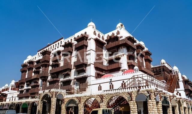 View of the ornate wooden balconies and white facade of Al Taybat International City Museum of Science and Information in Jeddah, Saudi Arabia. View of the ornate wooden balconies and white facade of Al Taybat International City Museum of Science and Information in Jeddah, Saudi Arabia.