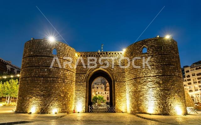 The illuminated stone towers of Bab Jadid gate serve as a grand entrance to the historic district of Al Balad in Jeddah, Saudi Arabia. The illuminated stone towers of Bab Jadid gate serve as a grand entrance to the historic district of Al Balad in Jeddah, Saudi Arabia.
