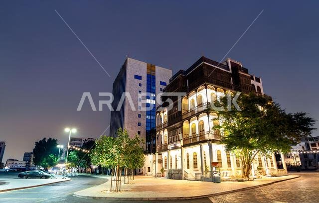 A beautifully illuminated traditional Hijazi house in the historic Al Balad district of Jeddah, Saudi Arabia at night