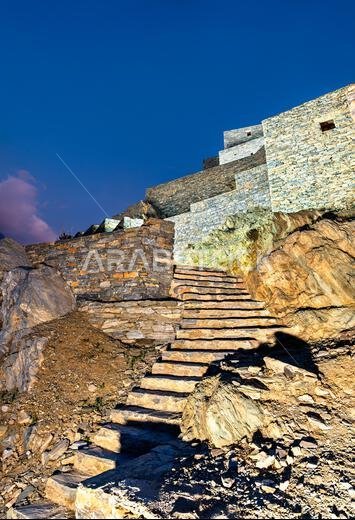 Traditional stone architecture and stairs at Thee Ain Heritage Village in the Al Bahah region of Saudi Arabia.