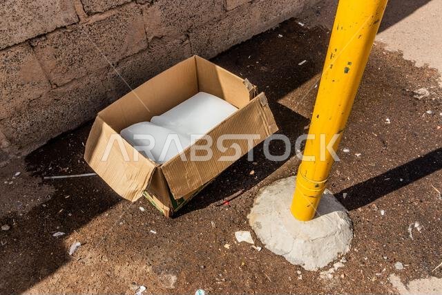 Cardboard box with ice on a sidewalk in Ha'il, Saudi Arabia