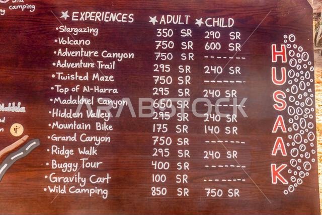 AL ULA, SAUDI ARABIA - NOVEMBER 8, 2021: Tourist activities price list in Al Ula Old town, Saudi Arabia AL ULA, SAUDI ARABIA - NOVEMBER 8, 2021: Tourist activities price list in Al Ula Old town, Saudi Arabia