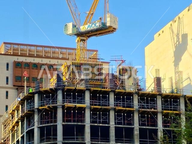 Medina, Saudi Arabia, June 26 2024: a new high building in Madinah city that is under construction, with a crane tower of ACC Arabian Construction Com Medina, Saudi Arabia, June 26 2024: a new high building in Madinah city that is under construction, with a crane tower of ACC Arabian Construction Com