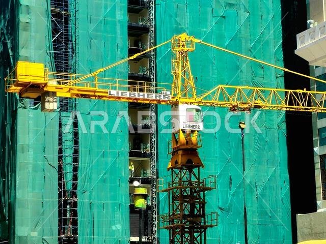 Medina, Saudi Arabia, June 27 2024: A construction site of a new high skyscraper building in Madinah city with a Liebherr crane tower at the construct