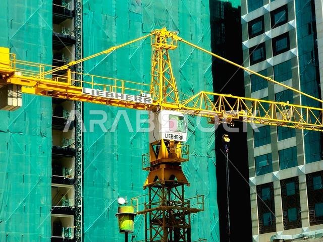 Medina, Saudi Arabia, June 27 2024: A construction site of a new high skyscraper building in Madinah city with a Liebherr crane tower at the construct