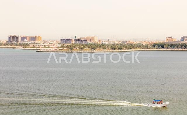Dammam coastline promenade street panorama with sea bay in the foreground, view from Murjan island, Saudi Arabia