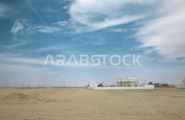 Building a new houses in the desert. Development building architecture. Traditional arab mud houses outdoor in Saudi Arabia with blue sky background.
