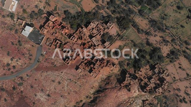 صورة جوية لمنازل مبنية من الحجر الأحمر والطين مع أسقف من الأردواز في قرية بمنطقة عسير، سرات عبيدة، المملكة العربية السعودية