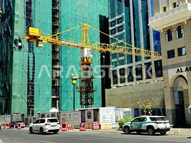 المدينة المنورة، المملكة العربية السعودية، 27 يونيو 2024: موقع بناء ناطحة سحاب جديدة في المدينة المنورة، مع برج رافعة من شركة ليبهر في موقع الإنشاء. المدينة المنورة، المملكة العربية السعودية، 27 يونيو 2024: موقع بناء ناطحة سحاب جديدة في المدينة المنورة، مع برج رافعة من شركة ليبهر في موقع الإنشاء.