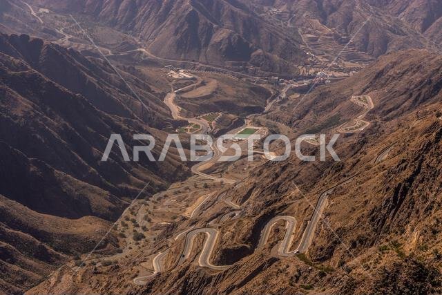 View of Al Souda mountains with a winding road near Abha, Saudi Arabia View of Al Souda mountains with a winding road near Abha, Saudi Arabia