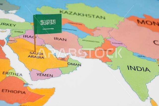 A map of the Middle East with a Saudi Arabia flag on it. The flag with green in color. Travel and government concept
