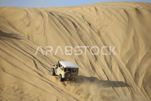 Nawan , Saudi Arabia  Jan 7 2023: 4x4 cars drift across Saudi Arabia’s striking sand desert. The vehicles perform thrilling maneuvers, on sand dunes