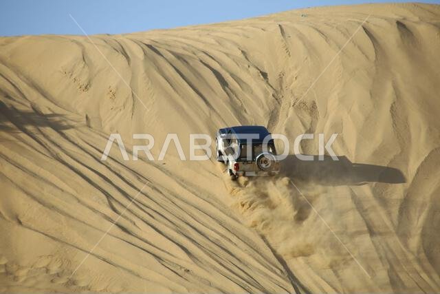 Nawan , Saudi Arabia  Jan 7 2023: 4x4 cars drift across Saudi Arabia’s striking sand desert. The vehicles perform thrilling maneuvers, on sand dunes
