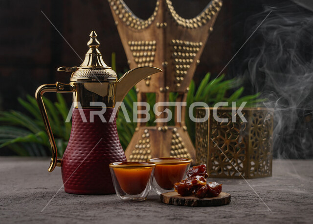 Arabic coffee pot on a wooden plate with two cups of coffee, Saudi hospitality, dates, hospitality and reception, Arabic coffee, Saudi Arabian incense