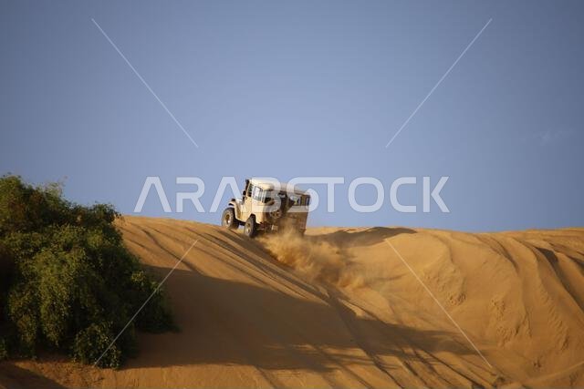 Nawan , Saudi Arabia  Jan 7 2023: 4x4 cars drift across Saudi Arabia’s striking sand desert. The vehicles perform thrilling maneuvers, on sand dunes