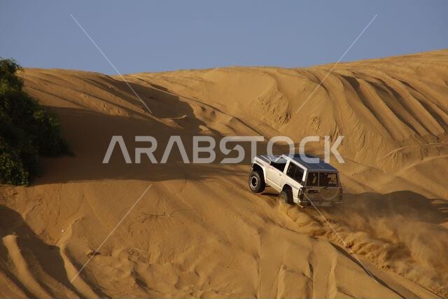 Nawan , Saudi Arabia  Jan 7 2023: 4x4 cars drift across Saudi Arabia’s striking sand desert. The vehicles perform thrilling maneuvers, on sand dunes