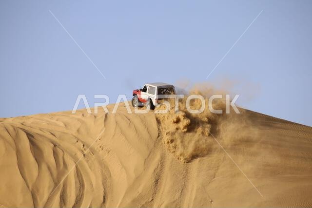 Nawan , Saudi Arabia  Jan 7 2023: 4x4 cars drift across Saudi Arabia’s striking sand desert. The vehicles perform thrilling maneuvers, on sand dunes