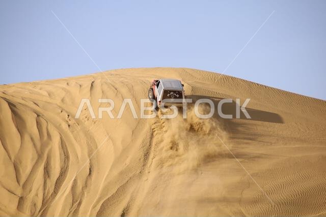 Nawan , Saudi Arabia  Jan 7 2023: 4x4 cars drift across Saudi Arabia’s striking sand desert. The vehicles perform thrilling maneuvers, on sand dunes