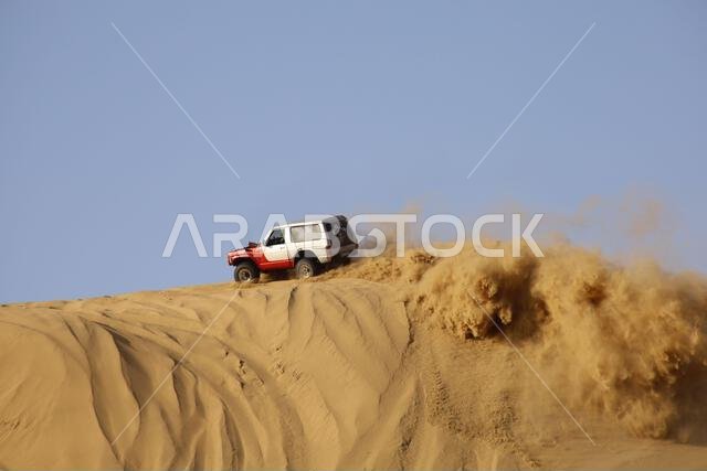 Nawan , Saudi Arabia  Jan 7 2023: 4x4 cars drift across Saudi Arabia’s striking sand desert. The vehicles perform thrilling maneuvers, on sand dunes