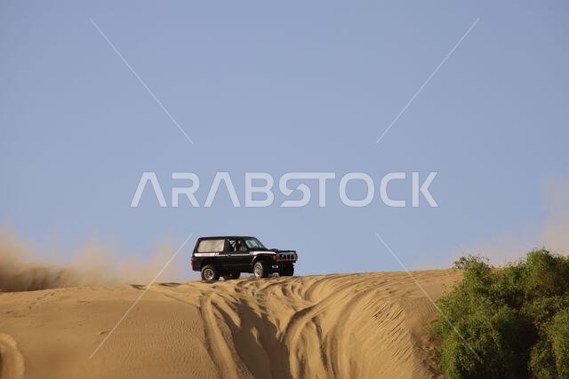 Nawan , Saudi Arabia  Jan 7 2023: 4x4 cars drift across Saudi Arabia’s striking sand desert. The vehicles perform thrilling maneuvers, on sand dunes