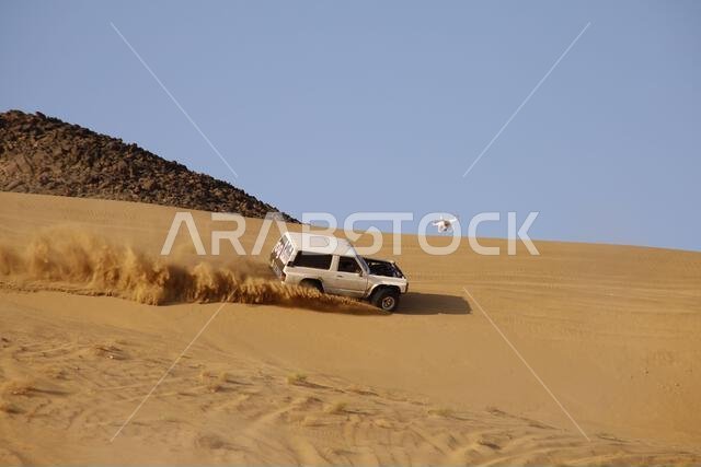 Nawan , Saudi Arabia  Jan 7 2023: 4x4 cars drift across Saudi Arabia’s striking sand desert. The vehicles perform thrilling maneuvers, on sand dunes
