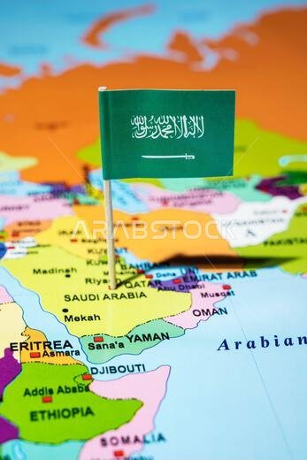 A map of the Middle East with a Saudi Arabia flag on it. The flag with green in color. Travel and government concept