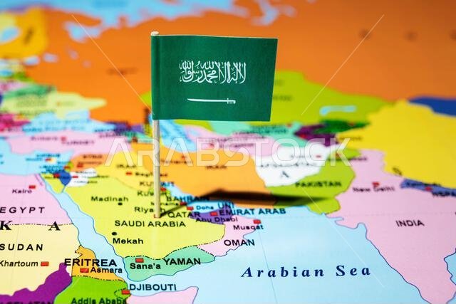 A map of the Middle East with a Saudi Arabia flag on it. The flag with green in color. Travel and government concept