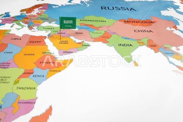 A map of the Middle East with a Saudi Arabia flag on it. The flag with green in color. Travel and government concept