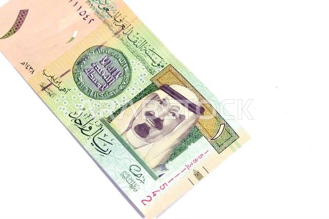 The Obverse side of 1 SAR one Saudi Arabian riyal banknote features king Abdullah Bin AbdulAziz, and the 1st Islamic coin, old ancient retro vintage S