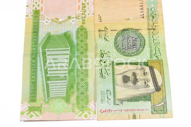 1 SAR one Saudi Arabian riyal banknote features King Abdullah and The building of the headquarters of the Saudi Arabian Monetary Agency and the arms O 1 SAR one Saudi Arabian riyal banknote features King Abdullah and The building of the headquarters of the Saudi Arabian Monetary Agency and the arms O