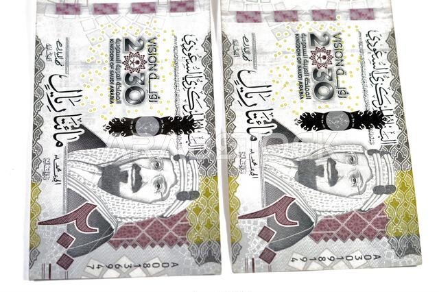 the obverse side of 200 SAR two hundred Saudi Arabian riyals banknote, features King Abdul Aziz Al Saud and Saudi kingdom vision of year 2030, issued