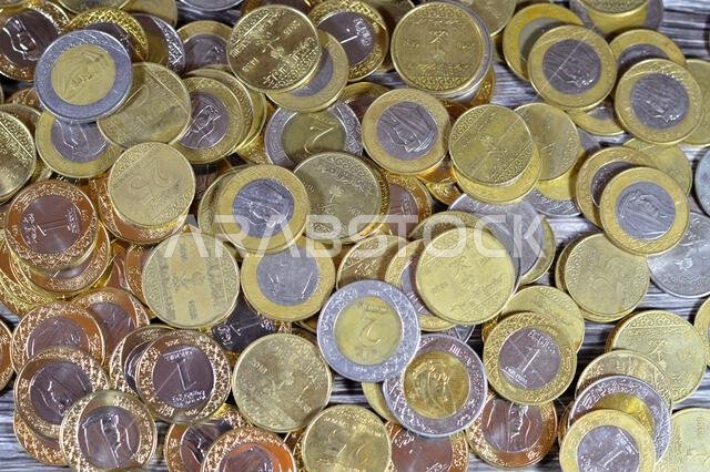 Various Saudi Arabia kingdom coins of different values and times, Old and new Saudi Riyals currency of 2 riyals, 1 riyal, half and quarter of a riyal