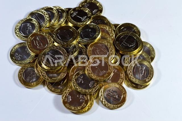 تتميز رزم العملات المعدنية من فئة ريال سعودي واحد بصورة الملك سلمان بن عبد العزيز، مع شعارات النبالة المتعددة داخل الزخارف النباتية، سعود