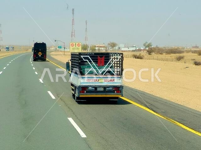 Makkah Madinah road, Saudi Arabia, June 25 2024: Isuzu transportation truck on the road for logistics and transportations, Isuzu is a Japanese multina Makkah Madinah road, Saudi Arabia, June 25 2024: Isuzu transportation truck on the road for logistics and transportations, Isuzu is a Japanese multina