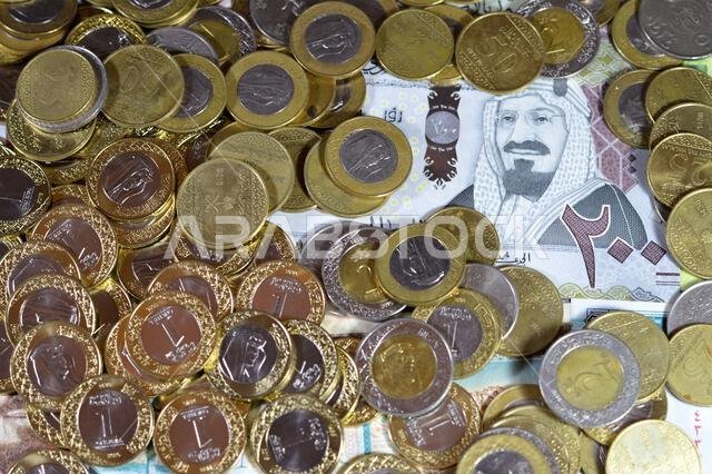 Coins of Saudi Arabian riyal, 2, 1, half and quarter coin on Saudi Arabia money banknotes of riyals bills, of different values, money and economic sta