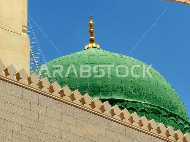 The Green dome of The Prophet's Mosque or Al Masjid Al Nabawi, a major site of pilgrimage that falls under the purview of the Custodian of the Two Hol The Green dome of The Prophet's Mosque or Al Masjid Al Nabawi, a major site of pilgrimage that falls under the purview of the Custodian of the Two Hol