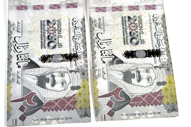 the obverse side of 200 SAR two hundred Saudi Arabian riyals banknote, features King Abdul Aziz Al Saud and Saudi kingdom vision of year 2030, issued
