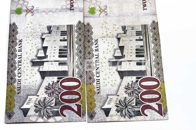 Reverse side of 200 SAR two hundred Saudi Arabian riyals banknote, features Qasr Al Hukm in Riyadh City with the bank name above the image and the den