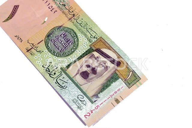 The Obverse side of 1 SAR one Saudi Arabian riyal banknote features king Abdullah Bin AbdulAziz, and the 1st Islamic coin, old ancient retro vintage S The Obverse side of 1 SAR one Saudi Arabian riyal banknote features king Abdullah Bin AbdulAziz, and the 1st Islamic coin, old ancient retro vintage S