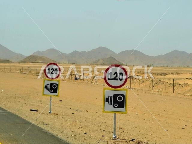 120 KM maximum speed limit sign with a speed camera road sign at Mecca Medina highway road, Tourism and pilgrimage concept in kingdom of Saudi Arabia 120 KM maximum speed limit sign with a speed camera road sign at Mecca Medina highway road, Tourism and pilgrimage concept in kingdom of Saudi Arabia