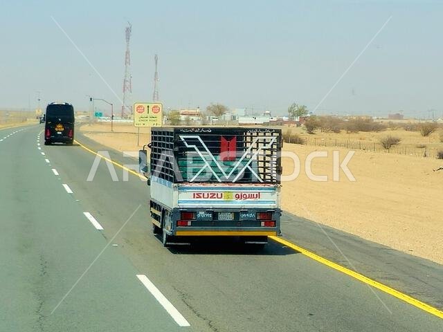 Makkah Madinah road, Saudi Arabia, June 25 2024: Isuzu transportation truck on the road for logistics and transportations, Isuzu is a Japanese multina