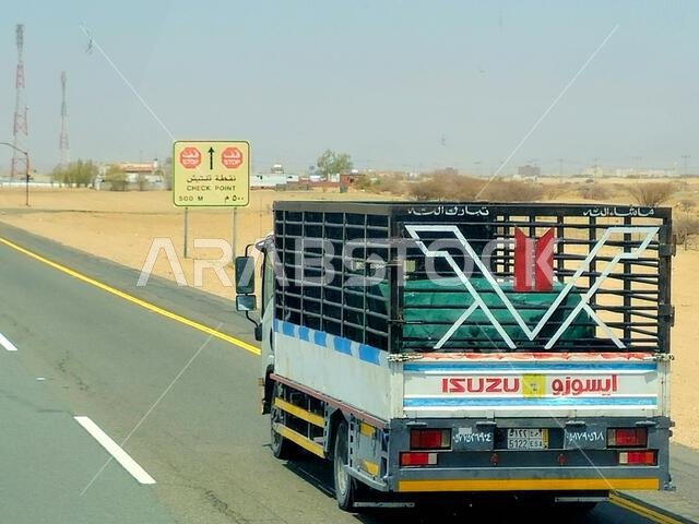 Makkah Madinah road, Saudi Arabia, June 25 2024: Isuzu transportation truck on the road for logistics and transportations, Isuzu is a Japanese multina Makkah Madinah road, Saudi Arabia, June 25 2024: Isuzu transportation truck on the road for logistics and transportations, Isuzu is a Japanese multina
