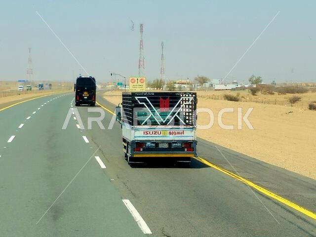 Makkah Madinah road, Saudi Arabia, June 25 2024: Isuzu transportation truck on the road for logistics and transportations, Isuzu is a Japanese multina Makkah Madinah road, Saudi Arabia, June 25 2024: Isuzu transportation truck on the road for logistics and transportations, Isuzu is a Japanese multina