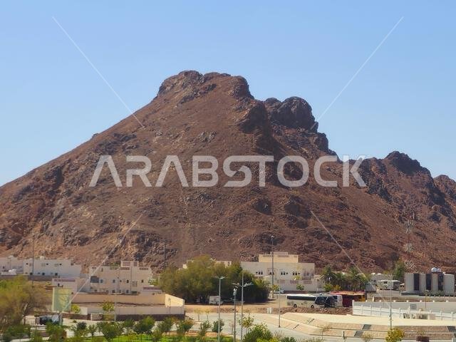 Mount Uhud, a mountain north of Medina, the site of the second battle between the Islamic prophet Muhammad and the polytheists of his tribe of Quraysh Mount Uhud, a mountain north of Medina, the site of the second battle between the Islamic prophet Muhammad and the polytheists of his tribe of Quraysh
