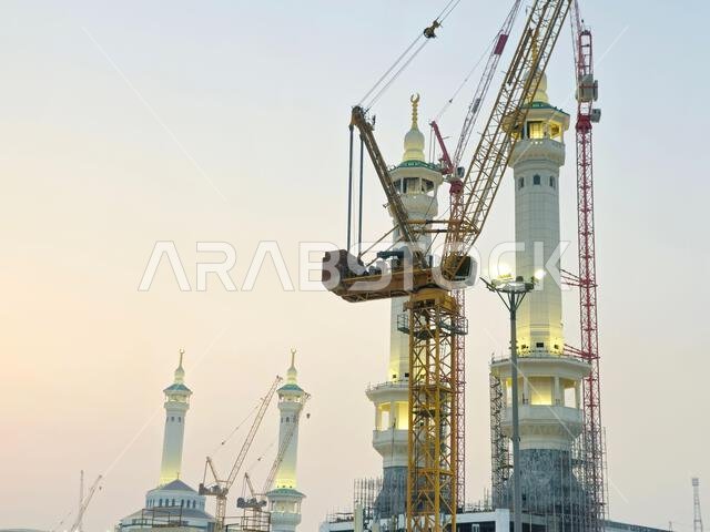 Mecca, Saudi Arabia, June 4 2024: Minarets of Al Masjid Al Haram mosque around the Kaaba in Hajj, pilgrimage, Umrah, with crane towers around it for m