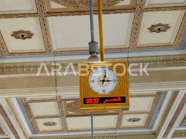 Mecca, Saudi Arabia, June 5 2024: A clock in Al Masjid al-Haram, the Sacred Mosque or the Great Mosque of Mecca, is considered to be the most signific Mecca, Saudi Arabia, June 5 2024: A clock in Al Masjid al-Haram, the Sacred Mosque or the Great Mosque of Mecca, is considered to be the most signific