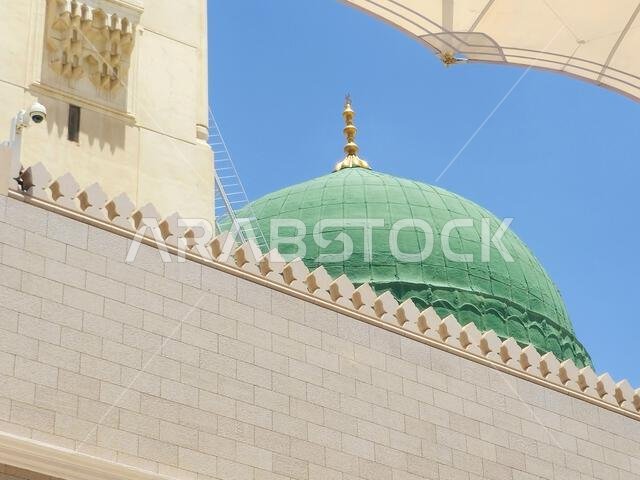 The Green dome of The Prophet's Mosque or Al Masjid Al Nabawi, a major site of pilgrimage that falls under the purview of the Custodian of the Two Hol The Green dome of The Prophet's Mosque or Al Masjid Al Nabawi, a major site of pilgrimage that falls under the purview of the Custodian of the Two Hol