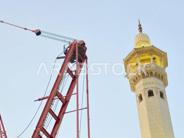 Mecca, Saudi Arabia, June 4 2024: Minarets of Al Masjid Al Haram mosque around the Kaaba in Hajj, pilgrimage, Umrah, with crane towers around it for m