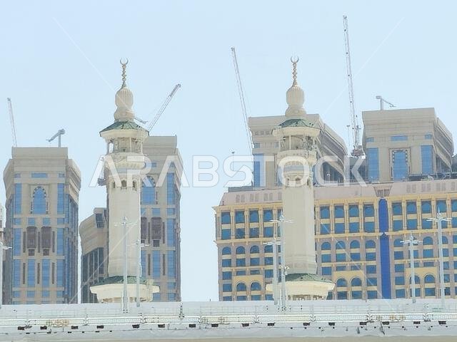 Mecca, Saudi Arabia, June 4 2024: Minarets of Al Masjid Al Haram mosque around the Kaaba in Hajj, pilgrimage, Umrah, with crane towers around it for m