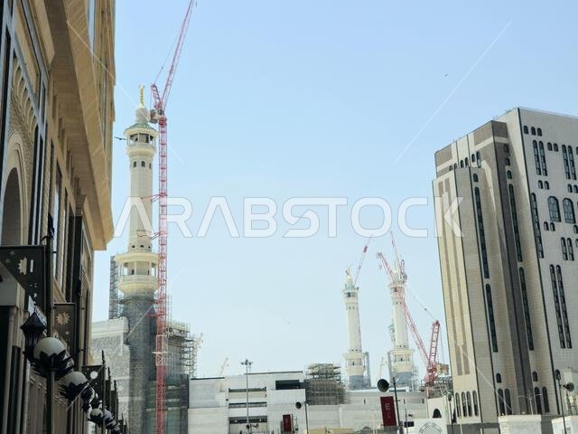 Mecca, Saudi Arabia, June 4 2024: Minarets of Al Masjid Al Haram mosque around the Kaaba in Hajj, pilgrimage, Umrah, with crane towers around it for m